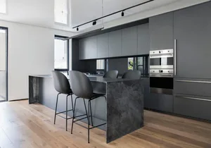 Modern kitchen with a granite countertop and stainless steel appliances.