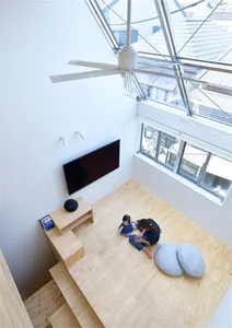 A modern living room with a wooden floor and a large window