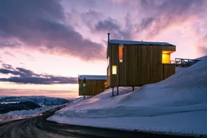 A modern residential wood cabin with a wooden exterior and a warm, inviting atmosphere.