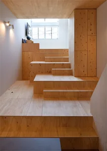 A modern staircase constructed with wooden panels, featuring a minimalist design with clean lines and natural light.