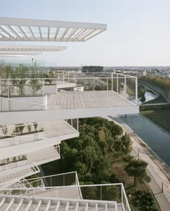 A parking lot featuring modern architectural elements such as timber and glass.