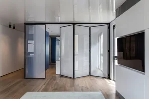 Modern interior space with glass partitions, hardwood flooring, and white walls.
