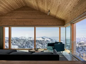 Modern living room with full views of wood, glass, and metal design elements.