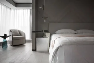 A minimalist bedroom featuring a metal panel wall, white bed, and wooden floor.