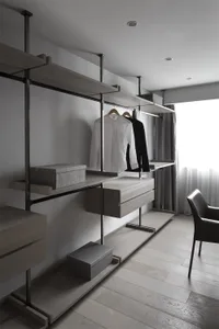 Modern closet with wooden shelves and metal rods, featuring a minimalist design with gray and white colors and a window.