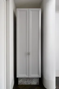 Modern interior design featuring a gray closet with concrete base, ideal for organizing clothing.
