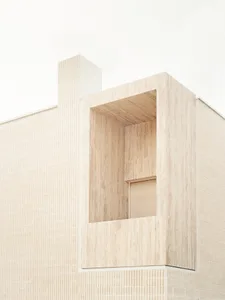 Sandstone exterior wall of a modern, minimalist building.