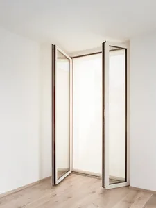 Glass and aluminum balcony doors in a modern room setting.