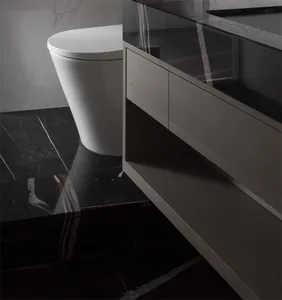 A modern bathroom with black marble floor tiles and white toilet.