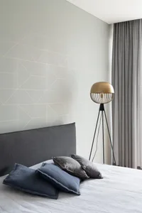 Gray fabric upholstered headboard and cotton bedding in a modern bedroom.