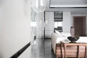 A contemporary living room featuring marble and wood elements.