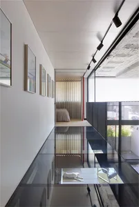 A modern minimalist living space featuring glass elements.