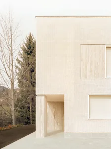A modern residential exterior featuring marble materials