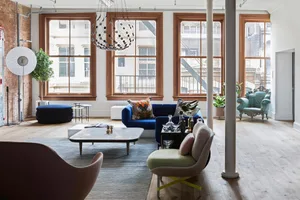 A modern interior living room with wooden floors and minimalist furniture.