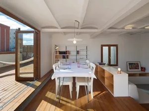 Modern living room with white walls, wood flooring, and minimalist decor.