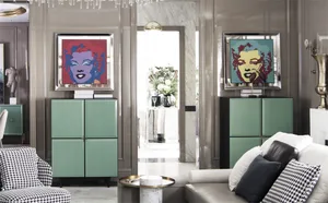 Modern living room with metallic green cabinets, colorful portraits of Marilyn Monroe, and contemporary furniture.