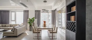 A modern dining room with a neutral color palette and furniture.