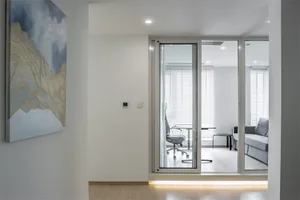 A modern office space featuring glass panel windows and a steel frame.