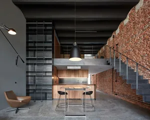 Industrial-style living space featuring exposed brick walls, metal furniture, and concrete flooring.
