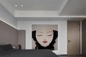A minimalist bedroom with a black and white wallpaper featuring a close-up of a woman's face.