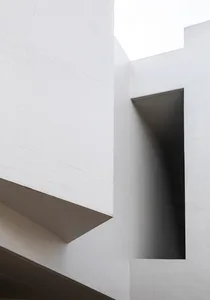 A close-up image of a modern building with a textured concrete exterior.