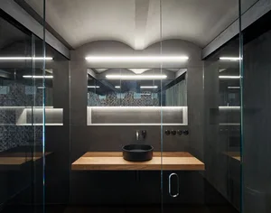 A modern bathroom featuring concrete and glass materials and a sleek black sink.