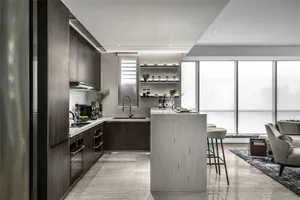 Modern kitchen featuring marble countertops and flooring.