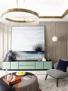 A modern living room featuring a large acrylic and watercolor painting in a sea-inspired color palette. Includes a black and