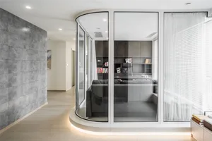 Modern minimalist living room with large glass walls and a sleek, contemporary design.
