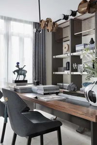 A modern office space featuring wooden desk, metal chairs, and glass shelves.