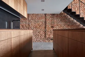 Industrial-style kitchen with reclaimed wood cabinets in a spacious, open-plan layout.
