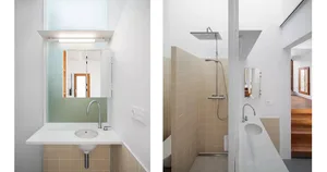 Minimalist bathroom interior with beige tiled walls, a white sink, and a frosted mirror above it.