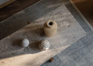 Modern ceramic decorative objects on a stone surface.