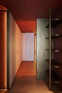 Modern closet with walnut wood cabinets and black metal shelving.
