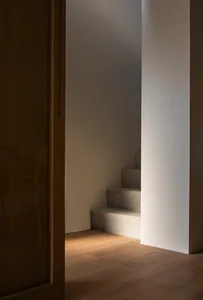 Concrete staircase with warm lighting in a modern interior space.