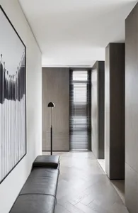 Modern interior corridor with wooden flooring and minimalist design elements.