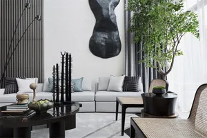 Modern living room with mixed media decor, featuring a gray sofa, coffee tables, and a potted plant.