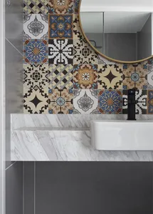 Modern bathroom with marble tiles and sink, featuring a collection of colorful decorative tiles on the wall.