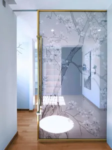 A modern interior design featuring a glass door with an ephemeral flower pattern.