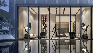 Modern lobby interior with glass walls and furniture, reflecting in the water.