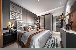 A modern bedroom showcasing fabric bedding, metallic accents, and glass elements.