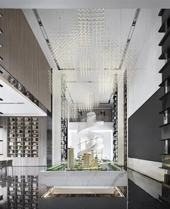 Modern lobby interior with glass chandeliers, marble accents, and metal spiral staircase.