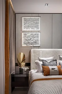 Modern bedroom featuring a wooden headboard adorned with fabric cushions.