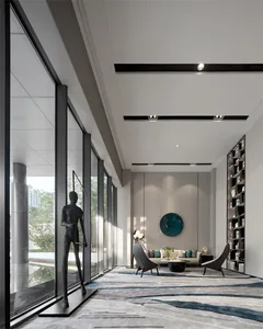 A modern lobby interior featuring concrete walls, glass windows, and metal accents.