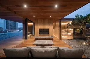 Modern minimalist living room featuring wooden furniture and flooring.
