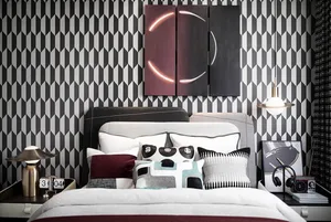 A modern bedroom with fabric headboard, metal accents, and wood elements.