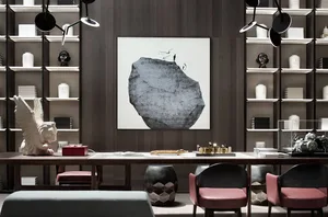 A modern home office featuring a large bookshelf, desk, and seating area with a minimalist and stylish design.