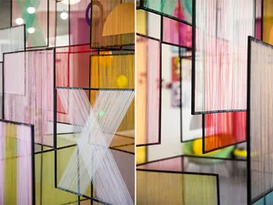 A colorful thread installation in a modern space