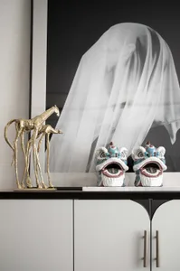A modern interior featuring decorative marble, ceramic, and metallic objects.