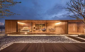 Modern residential interior decorated primarily with wooden elements and featuring a central tree。